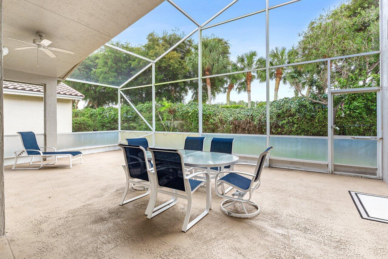 7320 Falls Road West Boynton Beach, FL 33437 - Photo 28 of 29 a view of a chair and tables in the patio