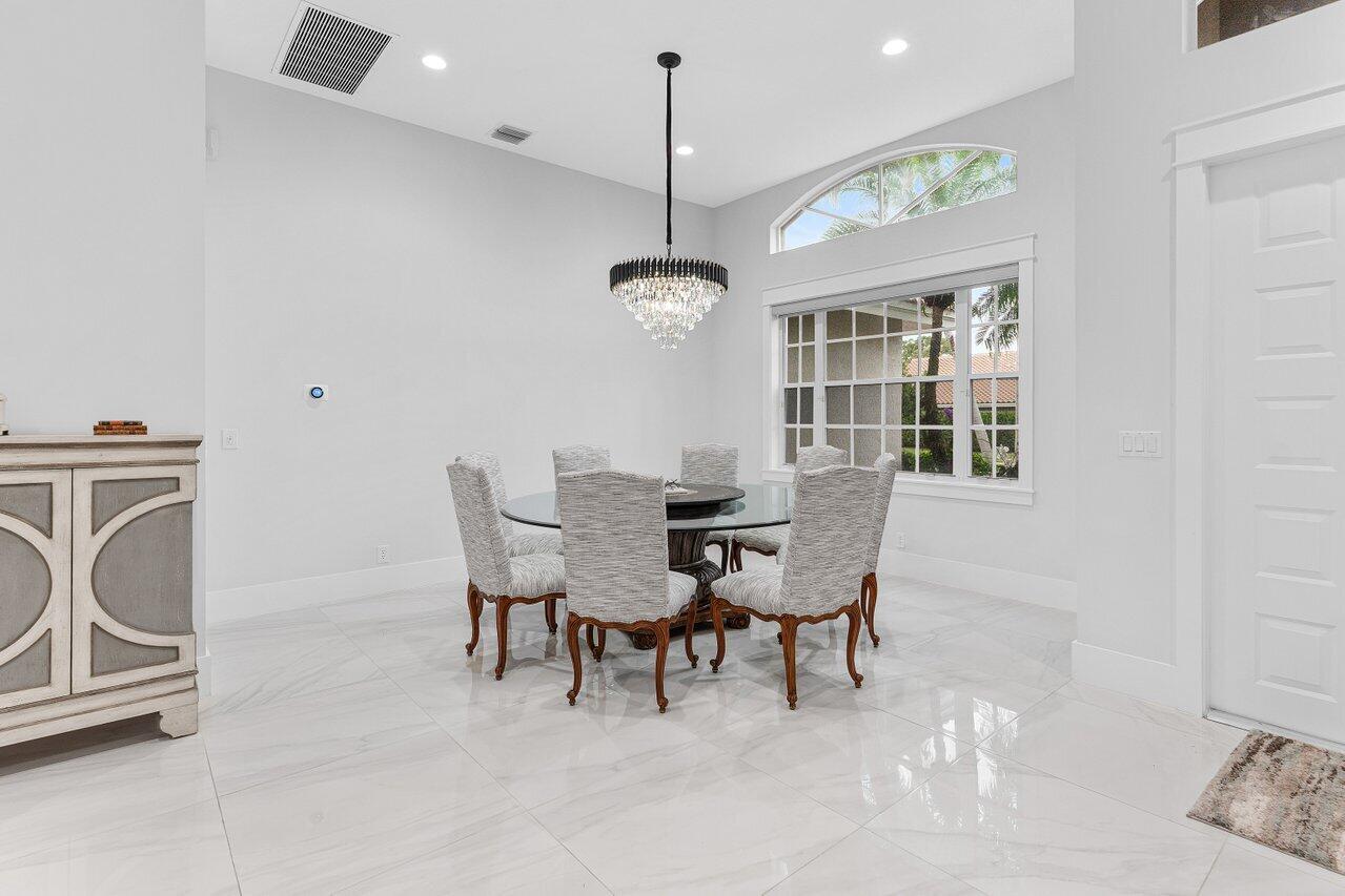 7320 Falls Road West Boynton Beach, FL 33437 - Photo 9 of 29 a dining room with furniture a chandelier and a window