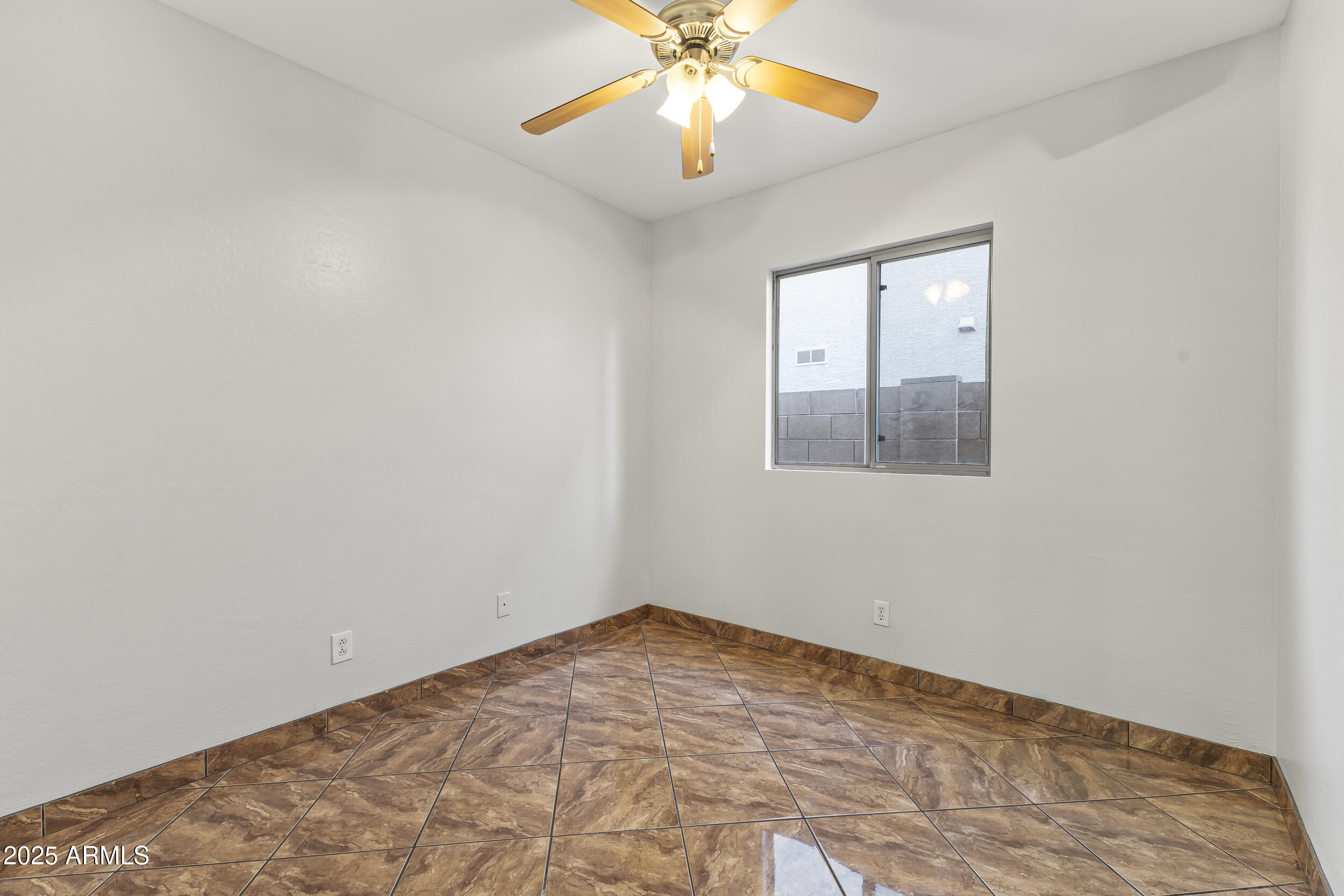 11185 West Coronado Road Avondale, AZ 85392 - Photo 10 of 46 a view of an empty room with a window