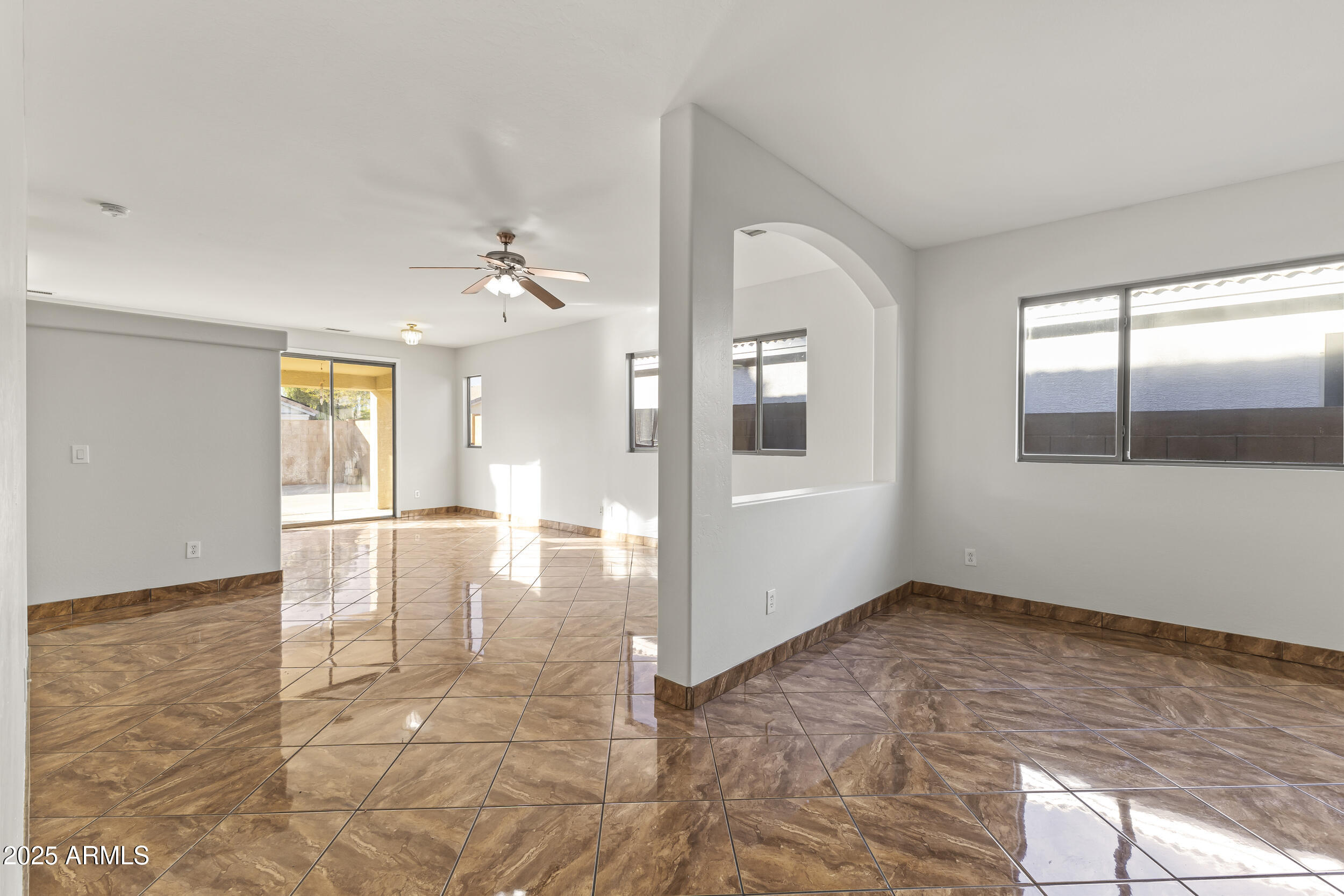 11185 West Coronado Road Avondale, AZ 85392 - Photo 16 of 46 a view of an empty room with window and wooden floor