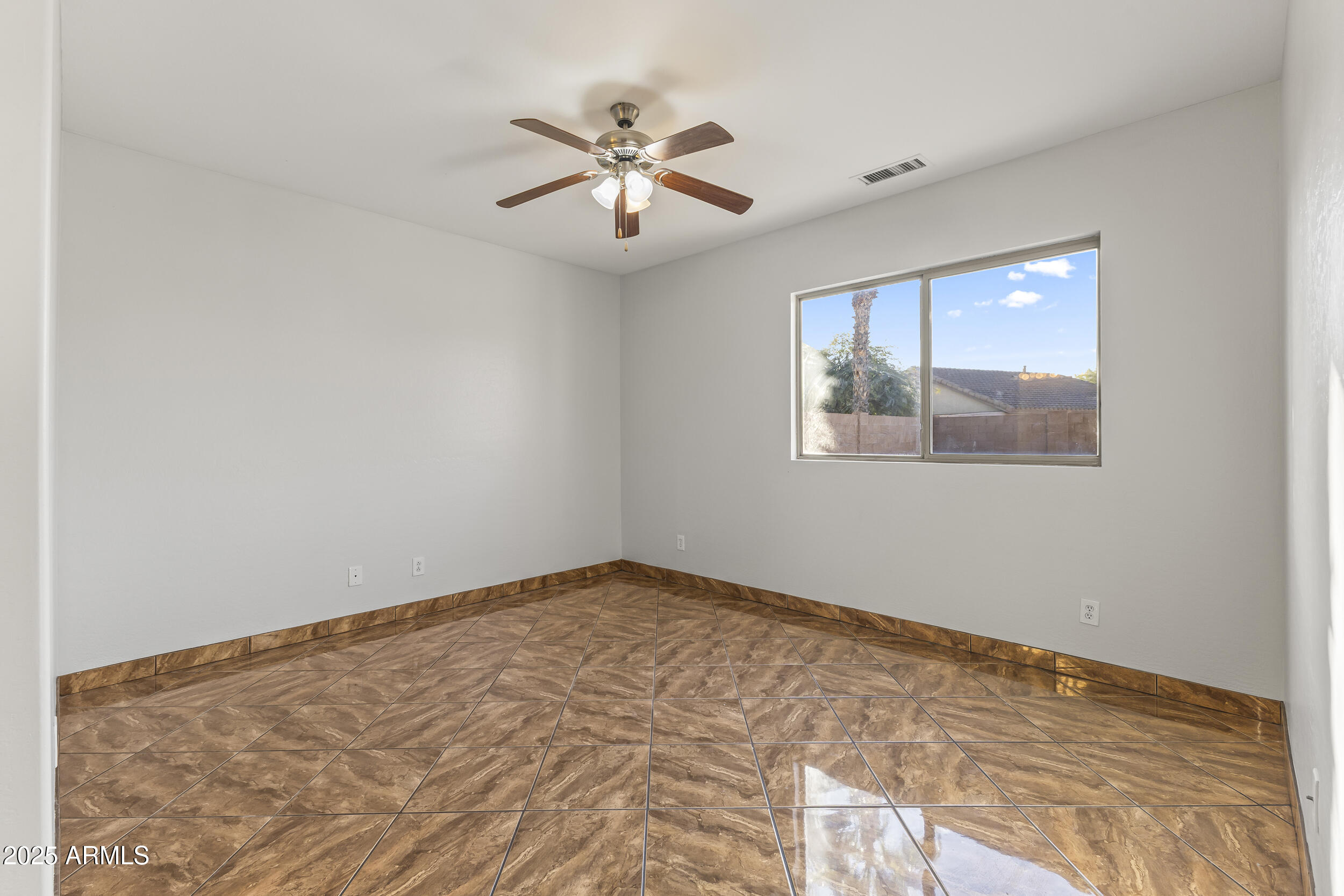 11185 West Coronado Road Avondale, AZ 85392 - Photo 18 of 46 a view of an empty room with a window