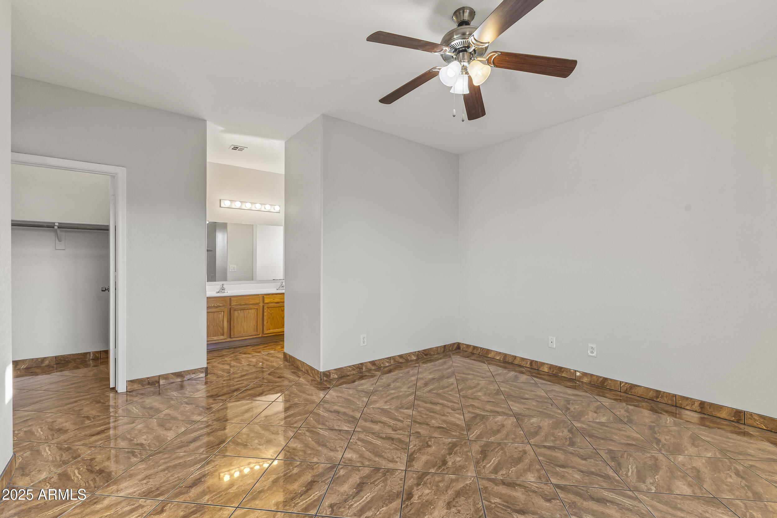 11185 West Coronado Road Avondale, AZ 85392 - Photo 19 of 46 a view of a room with a ceiling fan and a kitchen view