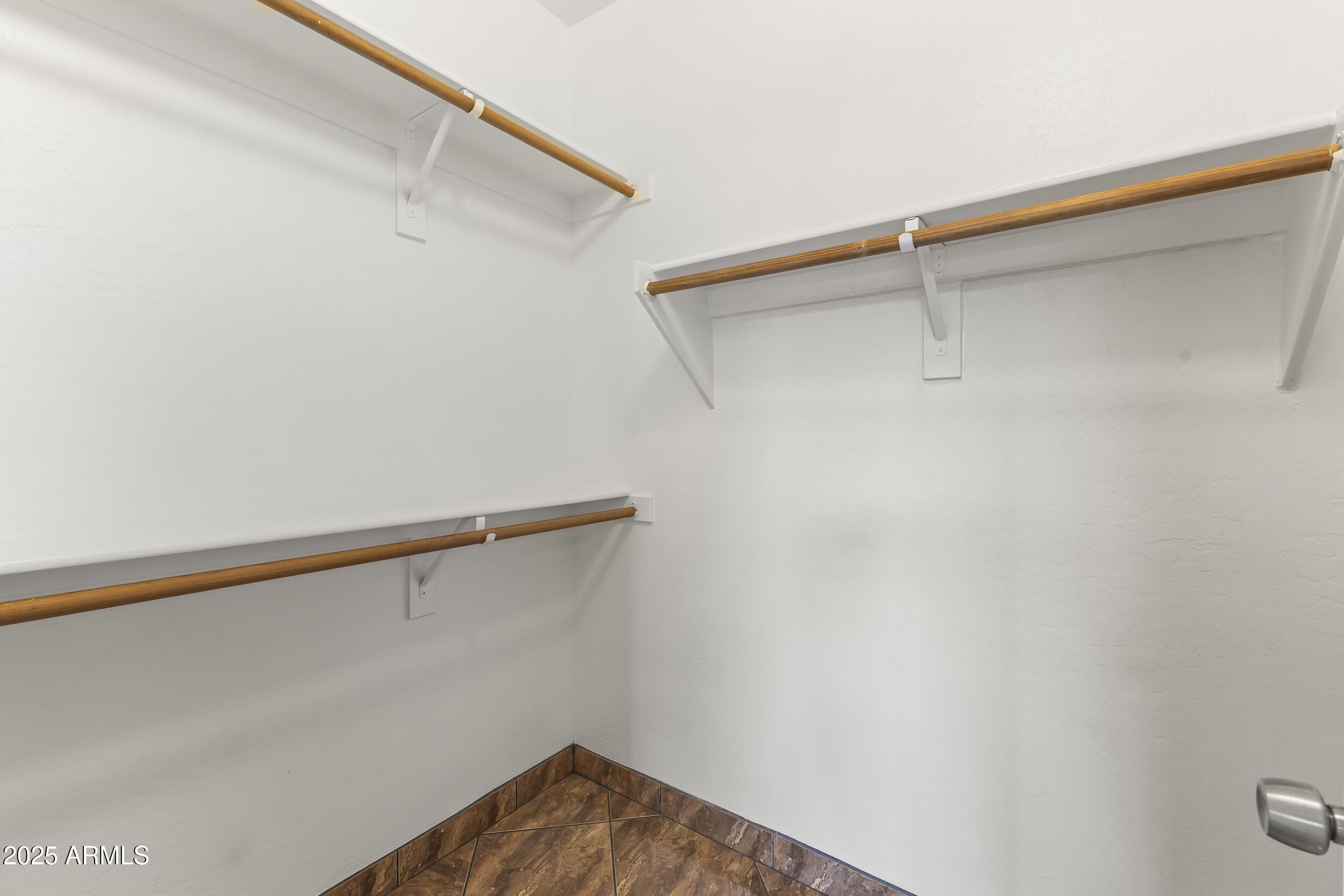 11185 West Coronado Road Avondale, AZ 85392 - Photo 21 of 46 a view of a room with racks on the wall