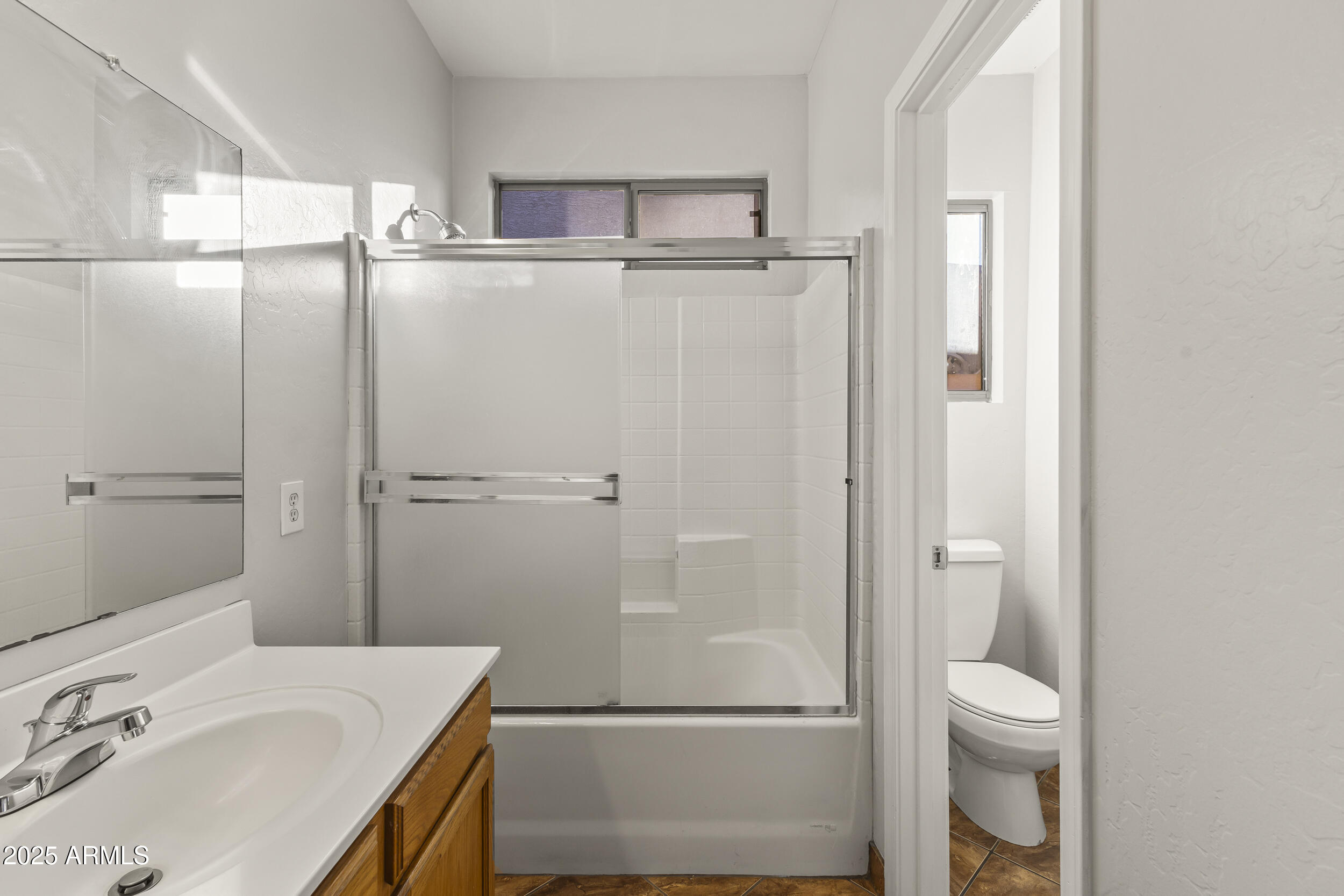 11185 West Coronado Road Avondale, AZ 85392 - Photo 23 of 46 a bathroom with a granite countertop sink toilet and shower
