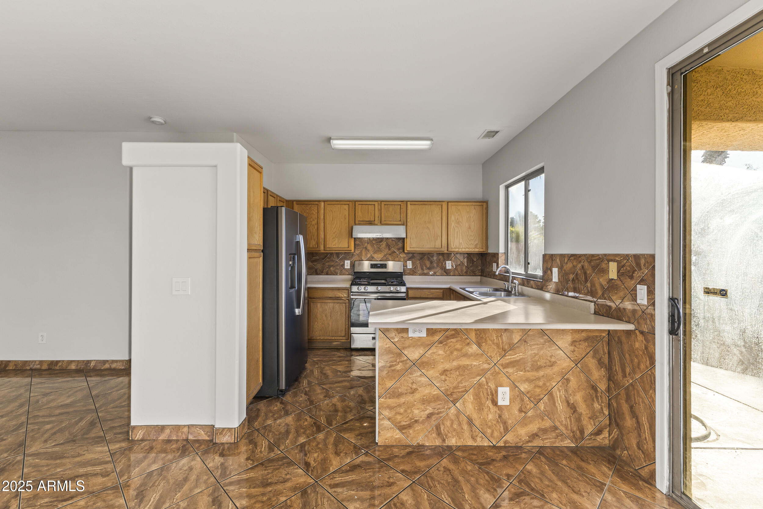 11185 West Coronado Road Avondale, AZ 85392 - Photo 25 of 46 a large white kitchen with a large window