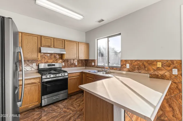 a large white kitchen with a large window