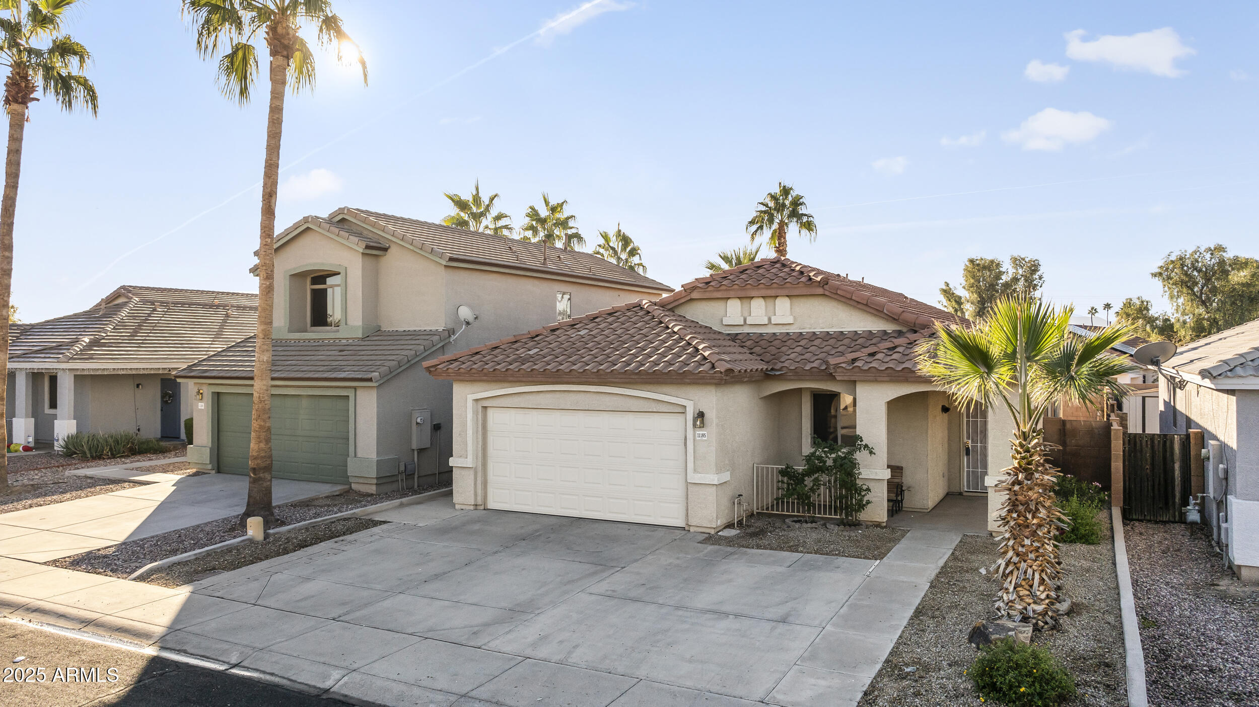 11185 West Coronado Road Avondale, AZ 85392 - Photo 34 of 46 a front view of a house with a yard and garage