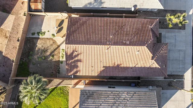 an aerial view of a house with a mountain