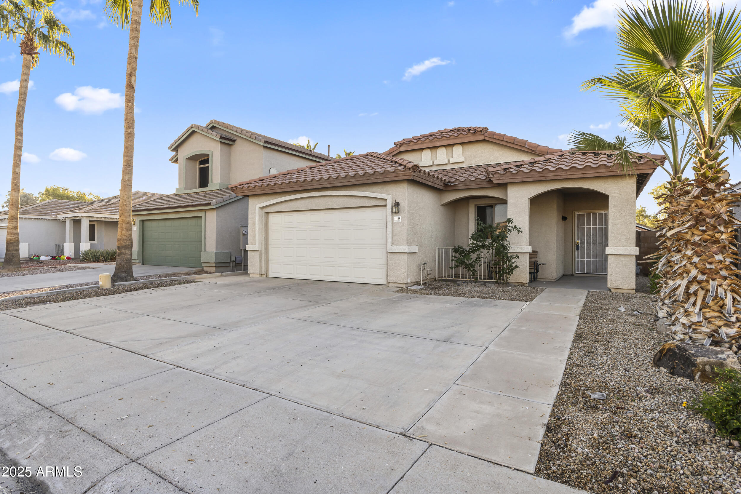 11185 West Coronado Road Avondale, AZ 85392 - Photo 3 of 46 a front view of a house with a garden