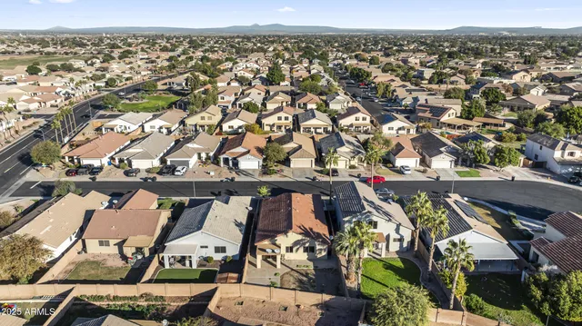 an aerial view of a residential houses with city view