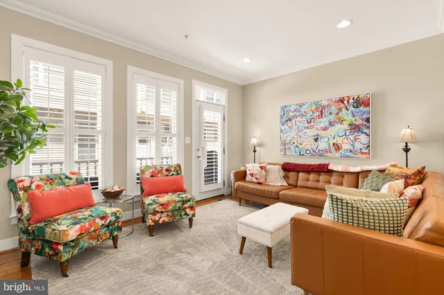 a living room with furniture and a large window with garden view