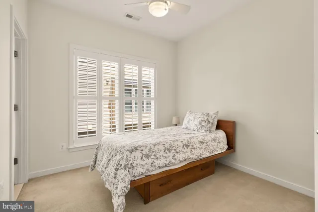 a bed sitting in a bedroom next to a window