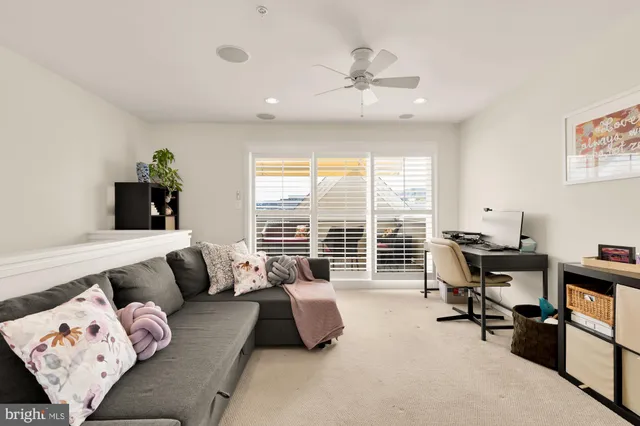 a bedroom with furniture and a large window