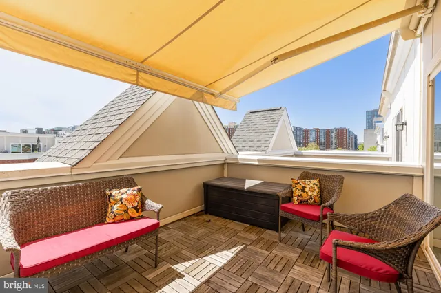 a balcony with furniture and a potted plant