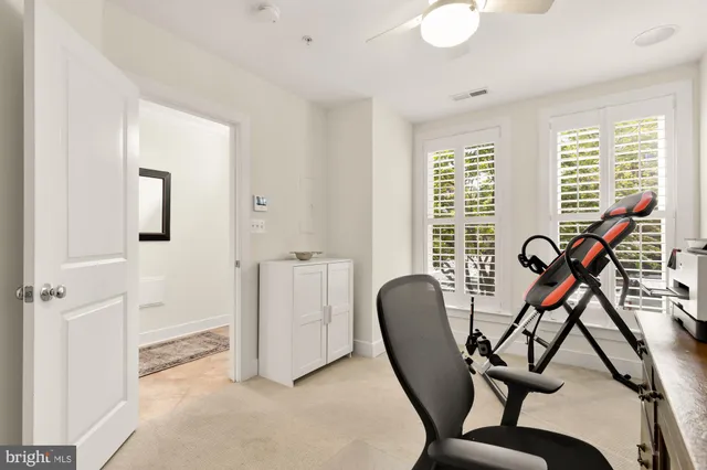 a view of a workspace with furniture and a window