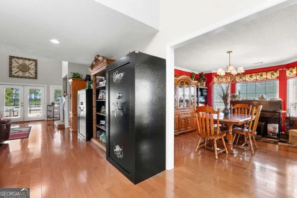 a view of a patio with table and chairs with wooden floor and fence