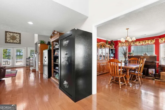 a view of a patio with table and chairs with wooden floor and fence