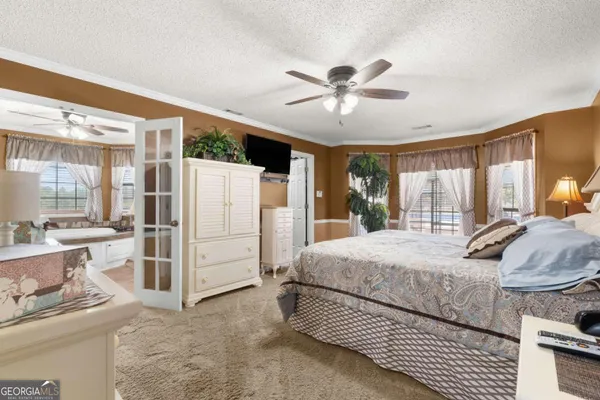 a kitchen with stainless steel appliances kitchen island granite countertop a table chairs and a refrigerator