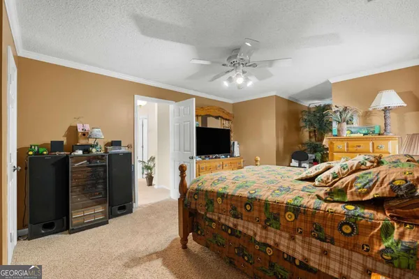a living room with furniture a flat screen tv and a large window
