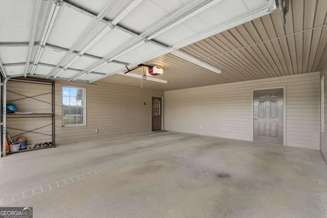 front view of a house with a yard and a garage
