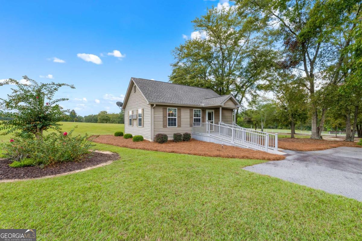 375 Dasher Street Lyons, GA 30436 - Photo 76 of 100 a front view of a house with yard and green space