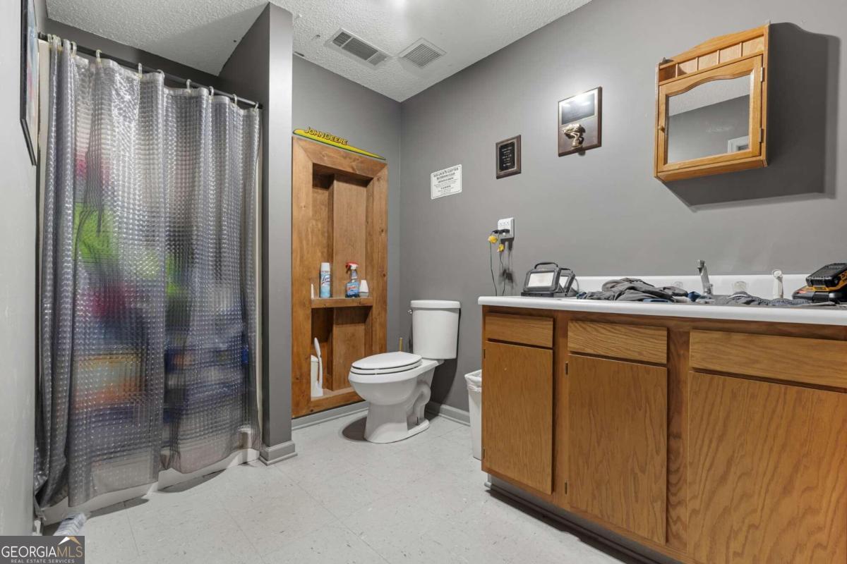 375 Dasher Street Lyons, GA 30436 - Photo 89 of 100 a bathroom with a sink a toilet and shower