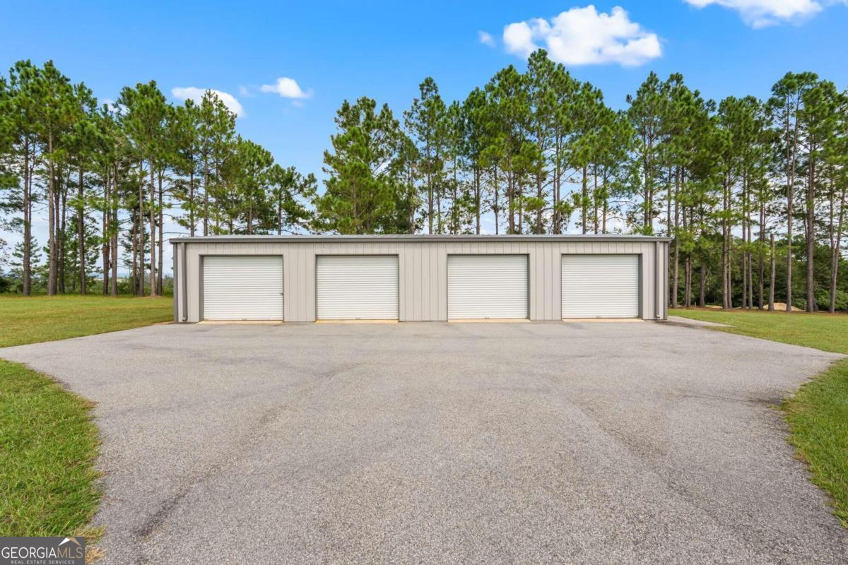 375 Dasher Street Lyons, GA 30436 - Photo 96 of 100 front view of a house with a yard and a garage