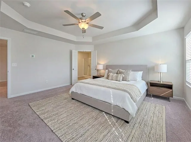 a bedroom with a large bed and a chandelier