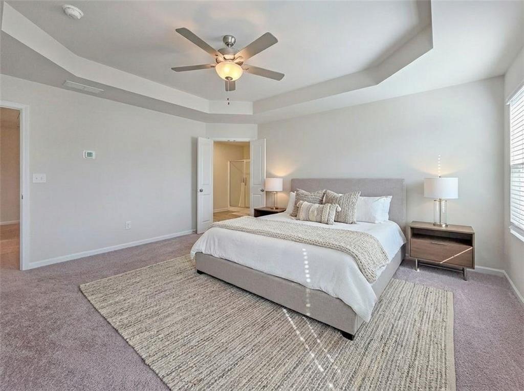 1120 Edinberg Drive Villa Rica, GA 30180 - Photo 17 of 35 a bedroom with a large bed and a chandelier