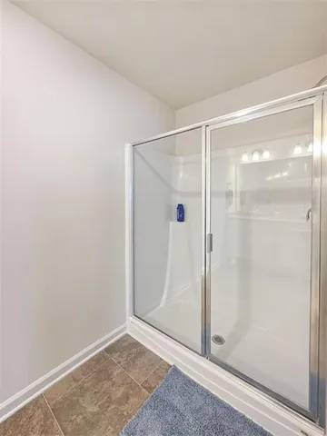 a bathroom with a glass shower door