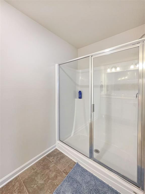 1120 Edinberg Drive Villa Rica, GA 30180 - Photo 21 of 35 a bathroom with a glass shower door