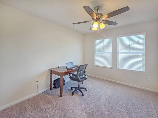 a workspace with chandelier and window