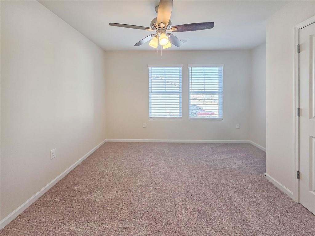 1120 Edinberg Drive Villa Rica, GA 30180 - Photo 27 of 35 an empty room with a window and a fan