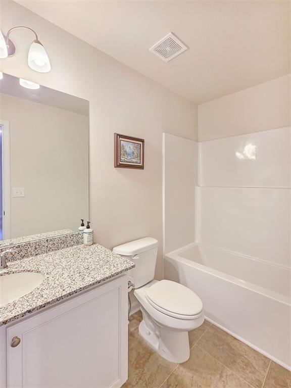 1120 Edinberg Drive Villa Rica, GA 30180 - Photo 28 of 35 a bathroom with a granite countertop sink a toilet and shower