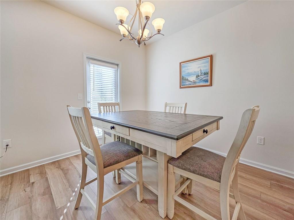 1120 Edinberg Drive Villa Rica, GA 30180 - Photo 10 of 35 a view of a dining room with furniture and a chandelier