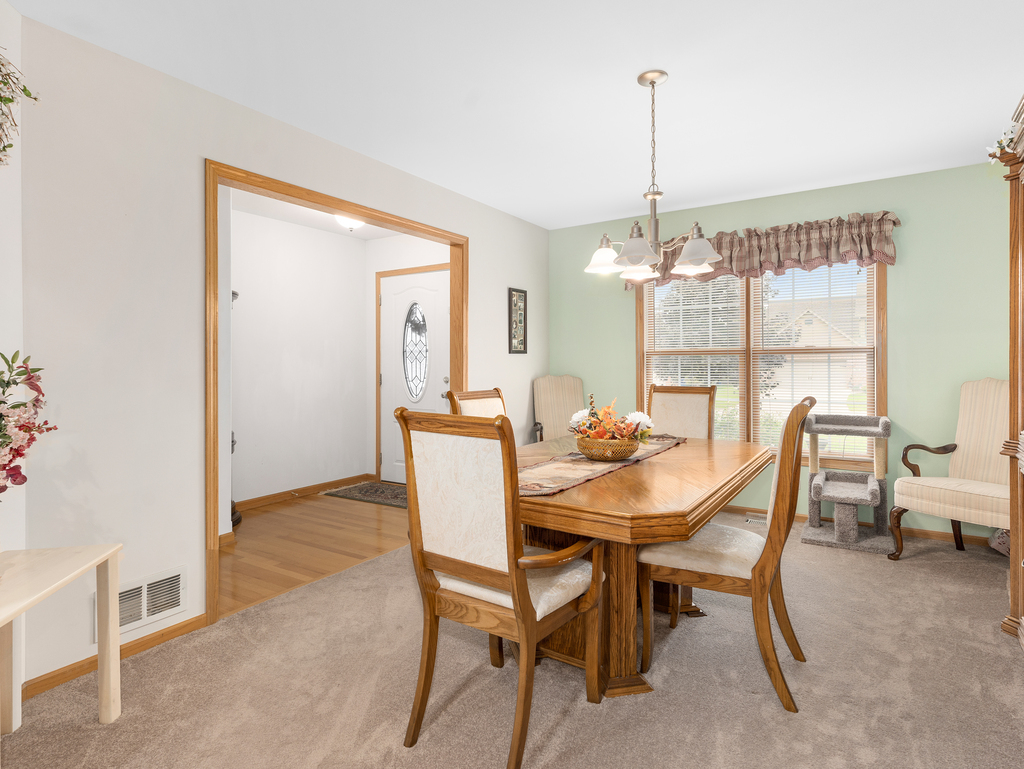 704 Clifford Drive Minooka, IL 60447 - Photo 11 of 25 a view of a dining room with furniture window and outside view