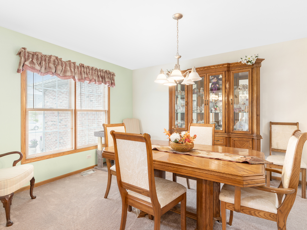 704 Clifford Drive Minooka, IL 60447 - Photo 12 of 25 a dining room with furniture and window