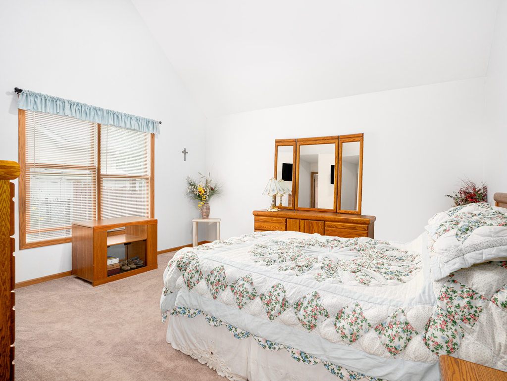 704 Clifford Drive Minooka, IL 60447 - Photo 13 of 25 a bedroom with a large bed and a window