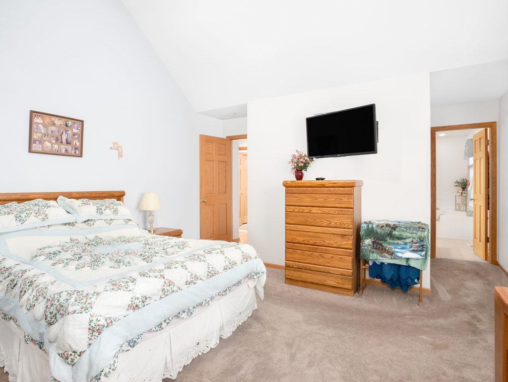 704 Clifford Drive Minooka, IL 60447 - Photo 14 of 25 a bedroom with a bed and flat screen tv