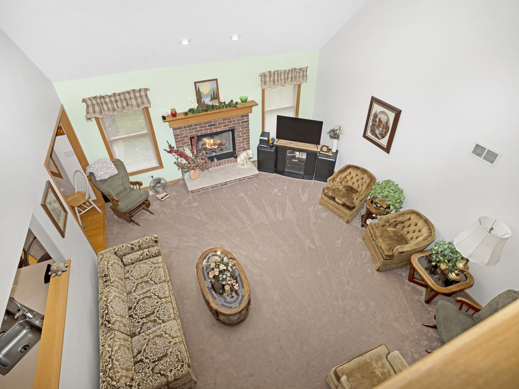 704 Clifford Drive Minooka, IL 60447 - Photo 20 of 25 a living room with furniture and a flat screen tv