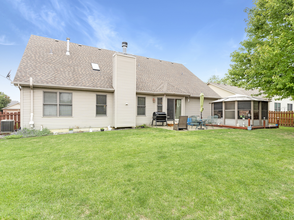 704 Clifford Drive Minooka, IL 60447 - Photo 24 of 25 a backyard of a house with table and chairs