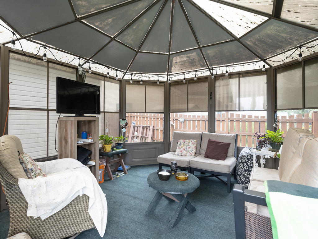 704 Clifford Drive Minooka, IL 60447 - Photo 25 of 25 a living room with furniture a flat screen tv and a large window