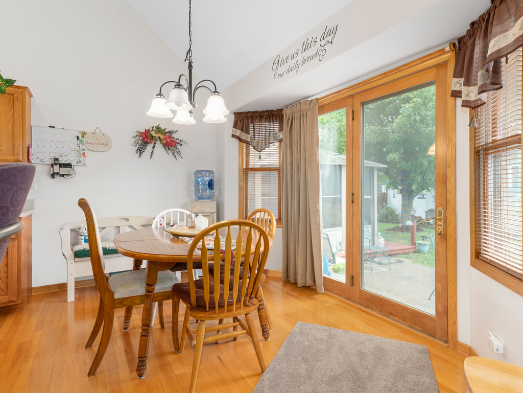 704 Clifford Drive Minooka, IL 60447 - Photo 6 of 25 a view of a dining room with furniture window and wooden floor
