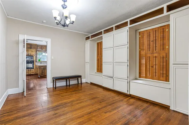 a view of a livingroom with furniture wooden floor and a window