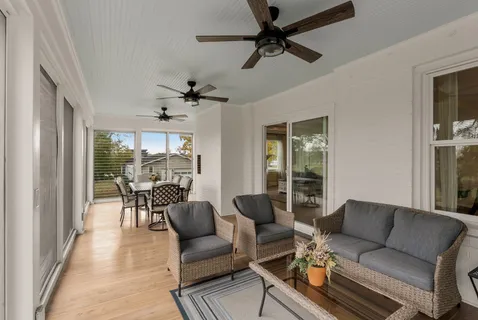 a dining room with furniture and a floor to ceiling window