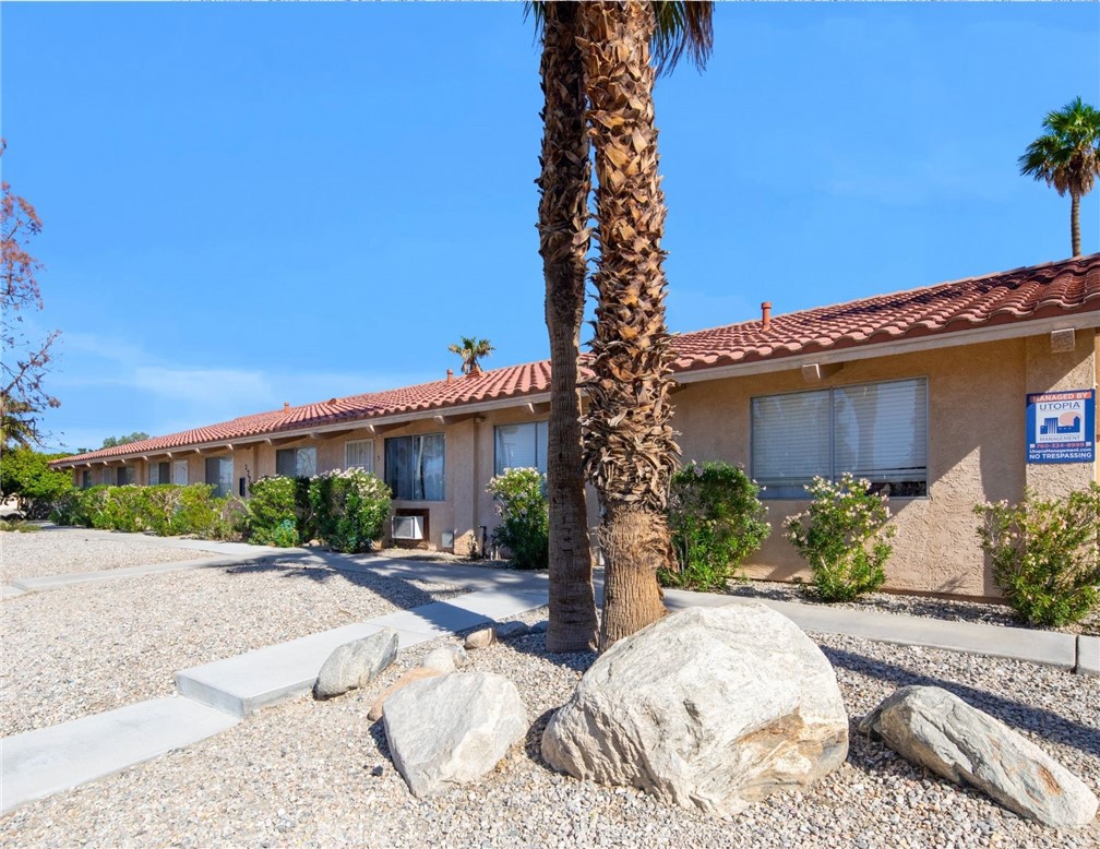 27700 Avenida Terrazo Cathedral City, CA 92234 - Photo 14 of 25 a front view of a house with a yard and potted plants