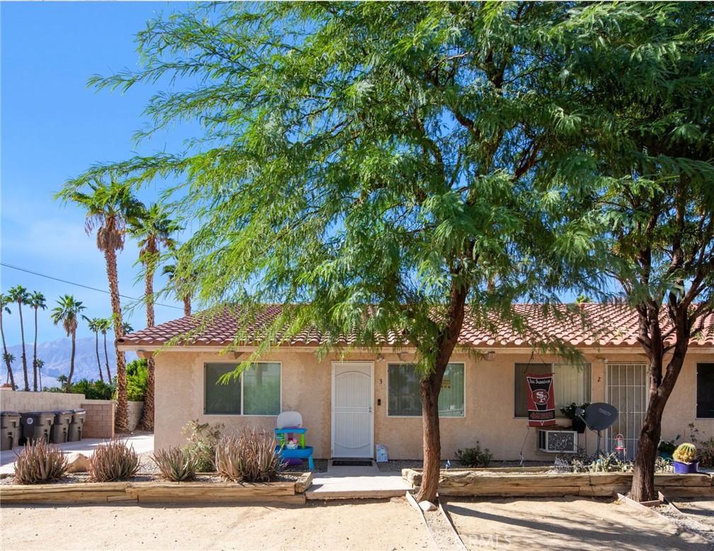 27700 Avenida Terrazo Cathedral City, CA 92234 - Photo 5 of 25 a front view of a house with a tree