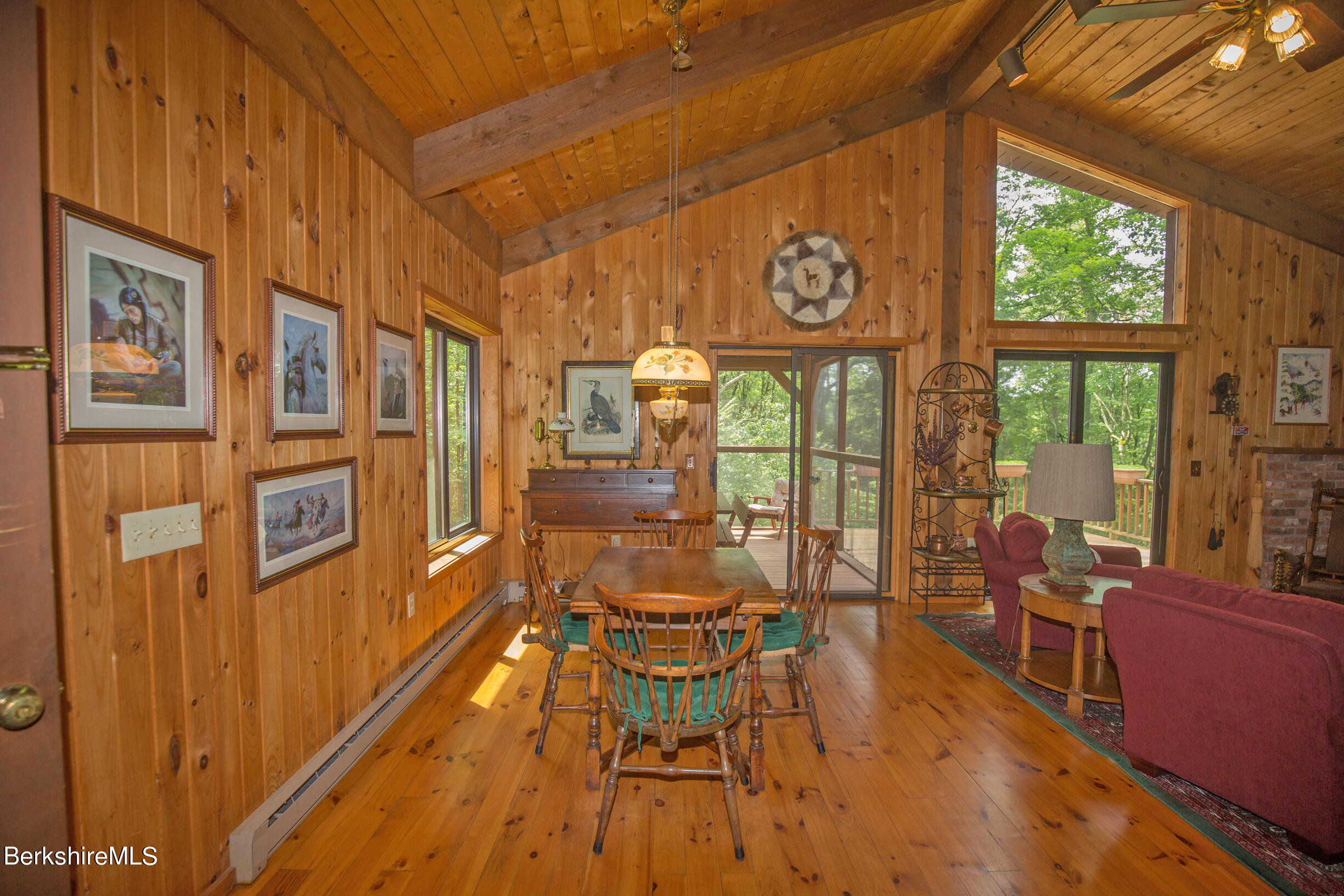 294 Tyringham Road Otis, MA 01253 - Photo 10 of 48 a view of a dining room with furniture a chandelier and wooden floor