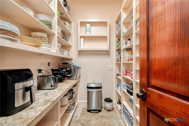 a kitchen with a stove and a refrigerator