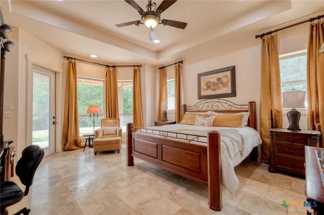 a bedroom with a bed and a large window